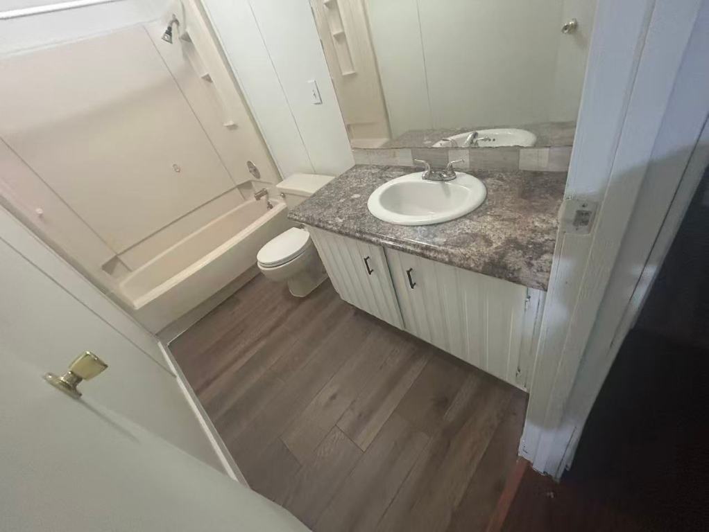23393 Nameless Road, Unit 123 Leander, TX 78641 - Photo 8 of 15 a bathroom with a sink a toilet and a mirror