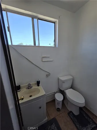 a bedroom with furniture and a rug