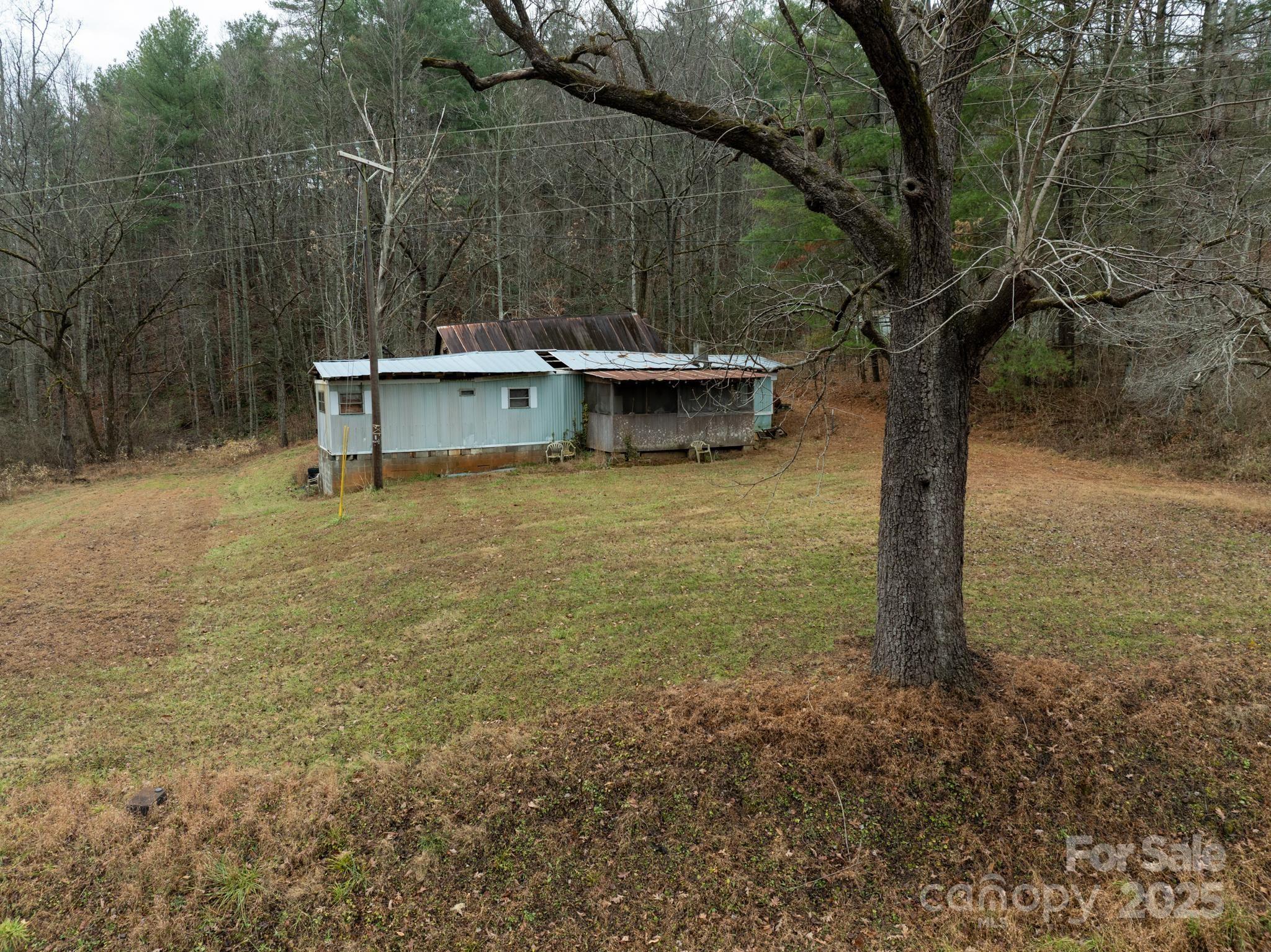 1864 Starcross Road Lenoir, NC 28645 - Photo 14 of 17 a backyard of a house with table and chairs