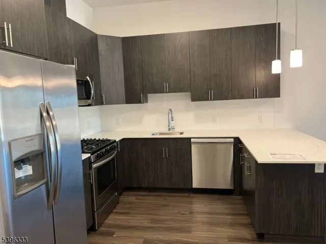 a kitchen with a refrigerator sink and stove