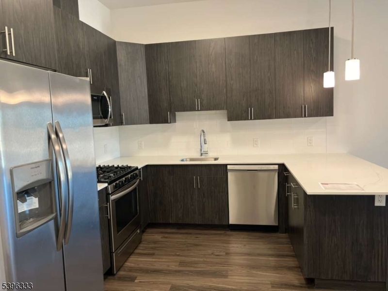a kitchen with a refrigerator sink and stove