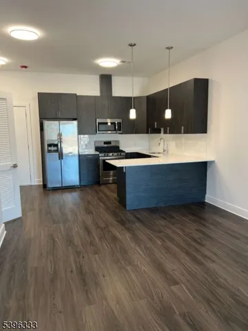 a kitchen with a sink cabinets and wooden floor