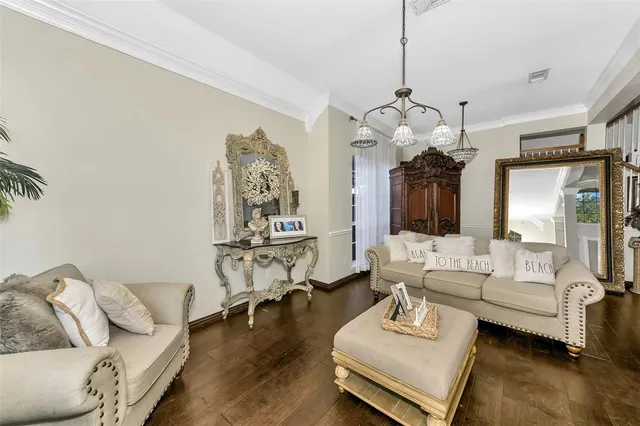 a living room with furniture and a chandelier