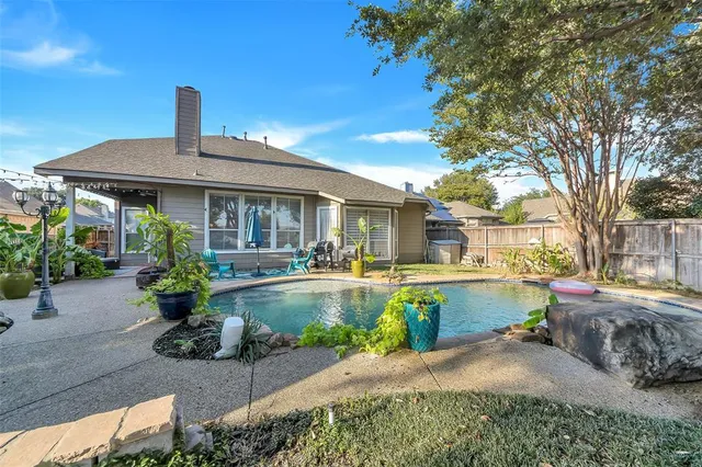 a front view of a house with swimming pool having outdoor seating