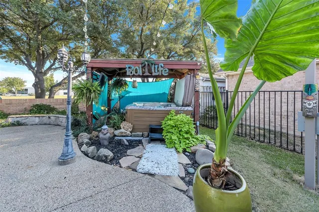 a view of a patio with chairs and plants