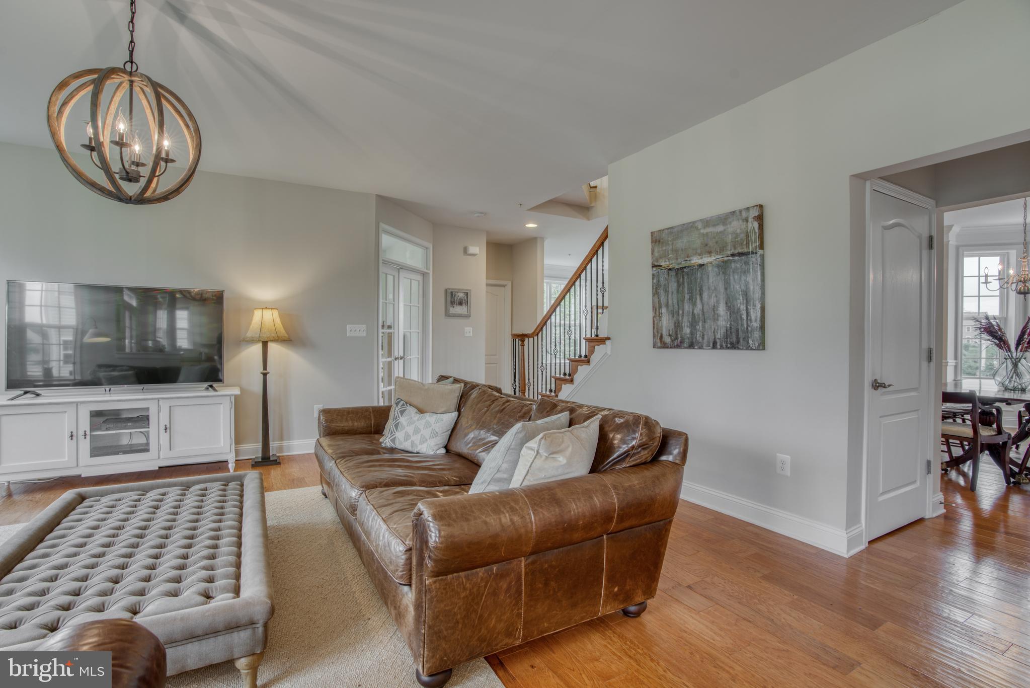 2344 Sweet Meadow Road Baltimore, MD 21209 - Photo 23 of 76 a living room with furniture a flat screen tv and kitchen view