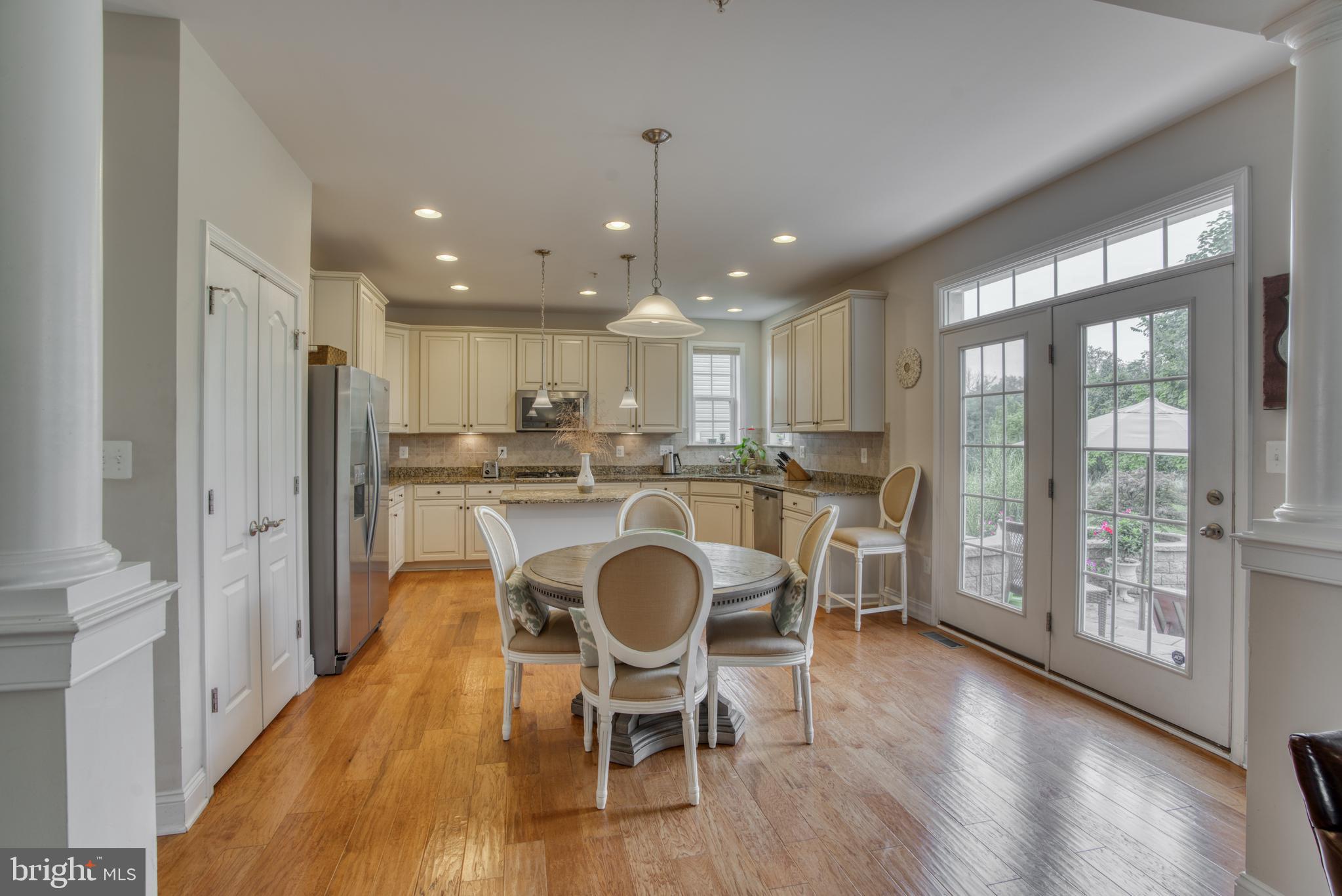 2344 Sweet Meadow Road Baltimore, MD 21209 - Photo 25 of 76 a kitchen with stainless steel appliances granite countertop a refrigerator a microwave oven a sink and wooden floor