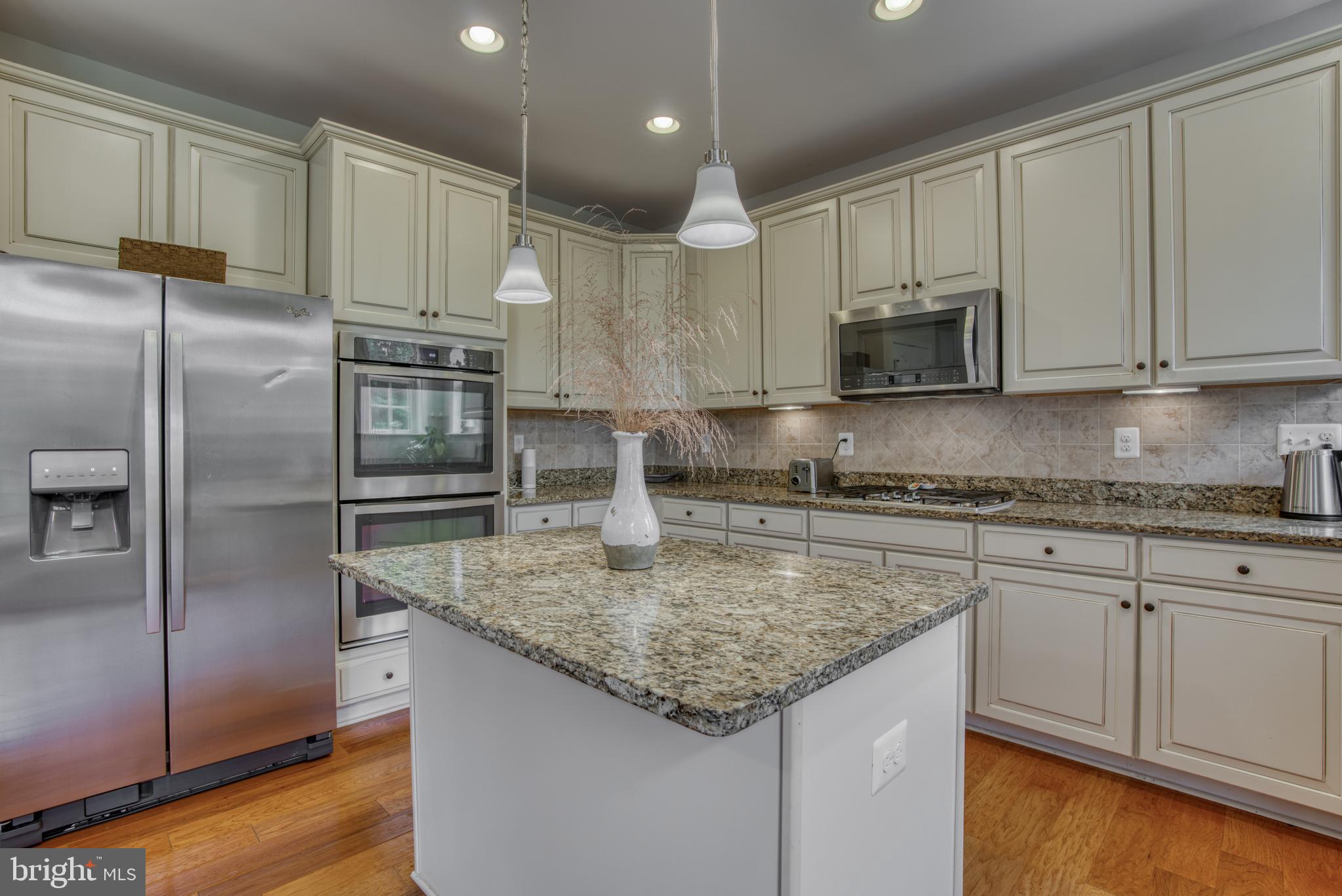 2344 Sweet Meadow Road Baltimore, MD 21209 - Photo 29 of 76 a kitchen with kitchen island granite countertop a sink stove and refrigerator