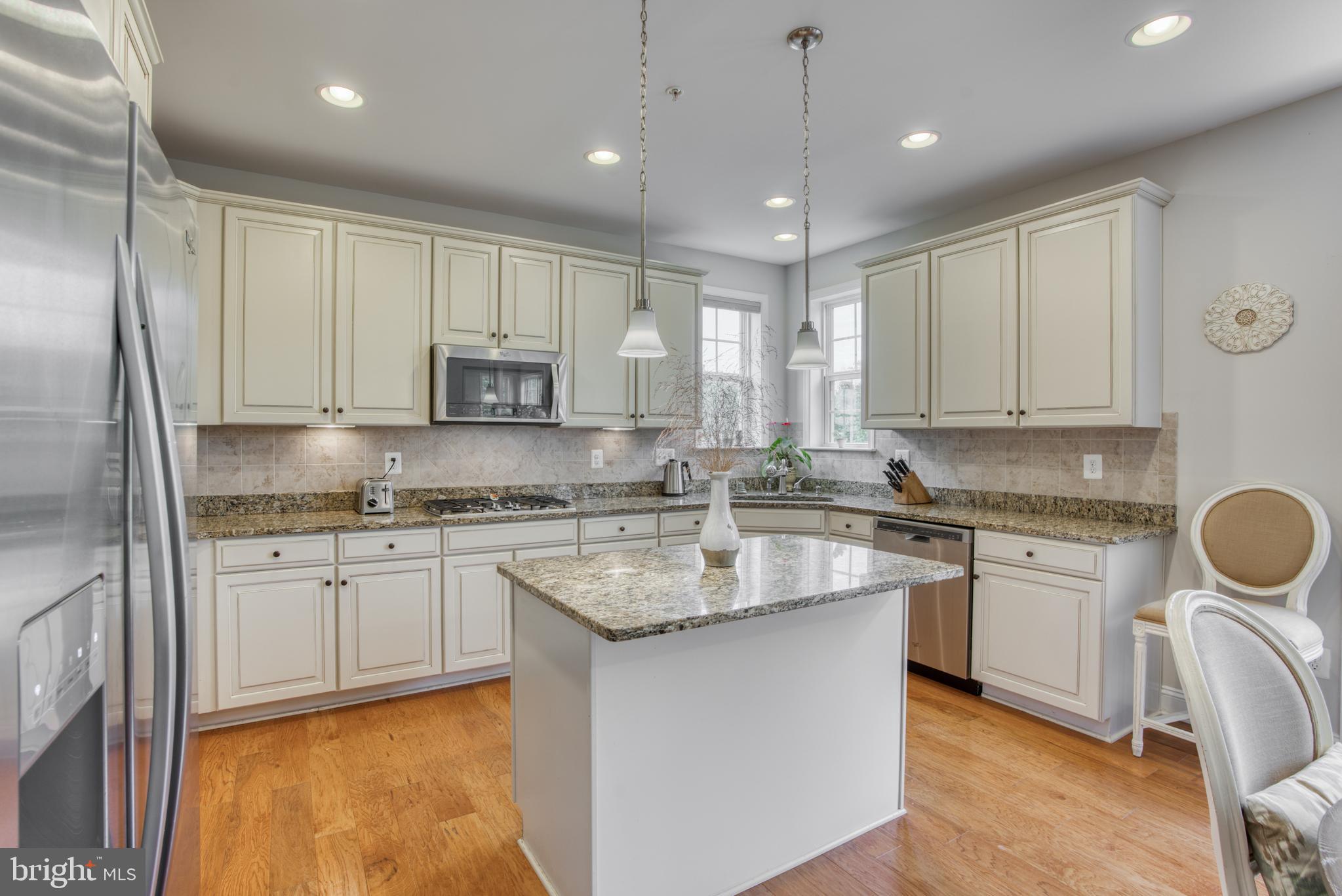 2344 Sweet Meadow Road Baltimore, MD 21209 - Photo 33 of 76 a kitchen with stainless steel appliances granite countertop a sink stove and refrigerator