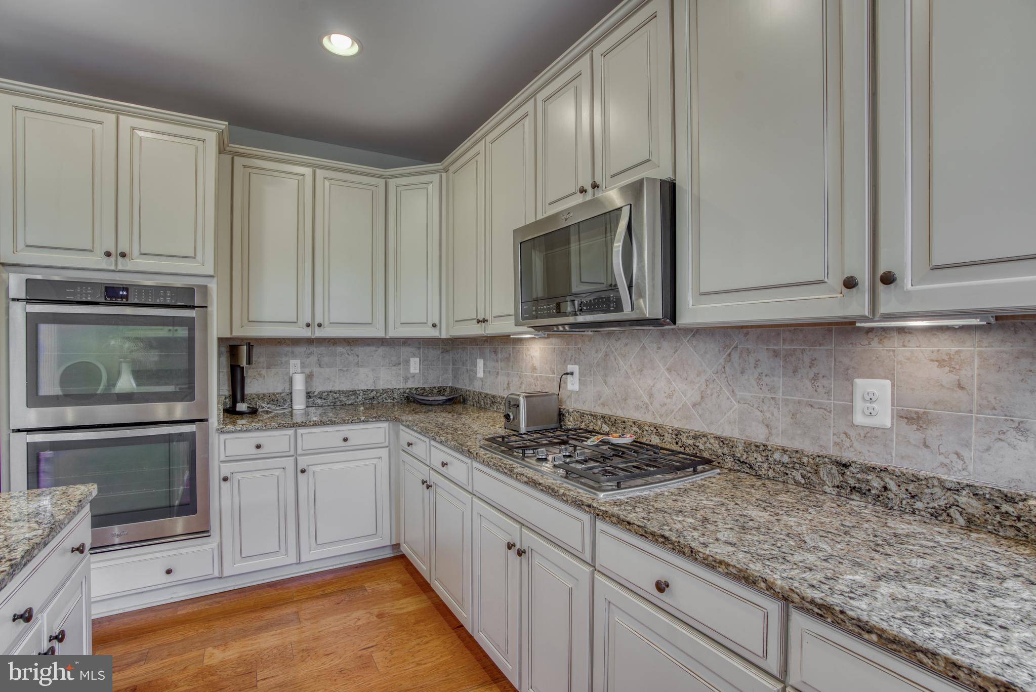 2344 Sweet Meadow Road Baltimore, MD 21209 - Photo 35 of 76 a kitchen with stainless steel appliances granite countertop a stove a sink and a microwave