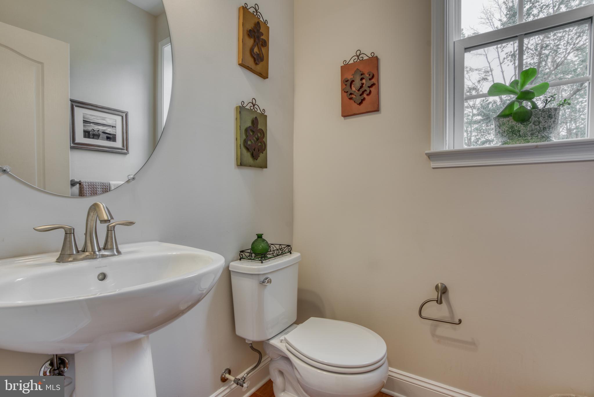2344 Sweet Meadow Road Baltimore, MD 21209 - Photo 40 of 76 a bathroom with a toilet a sink and mirror