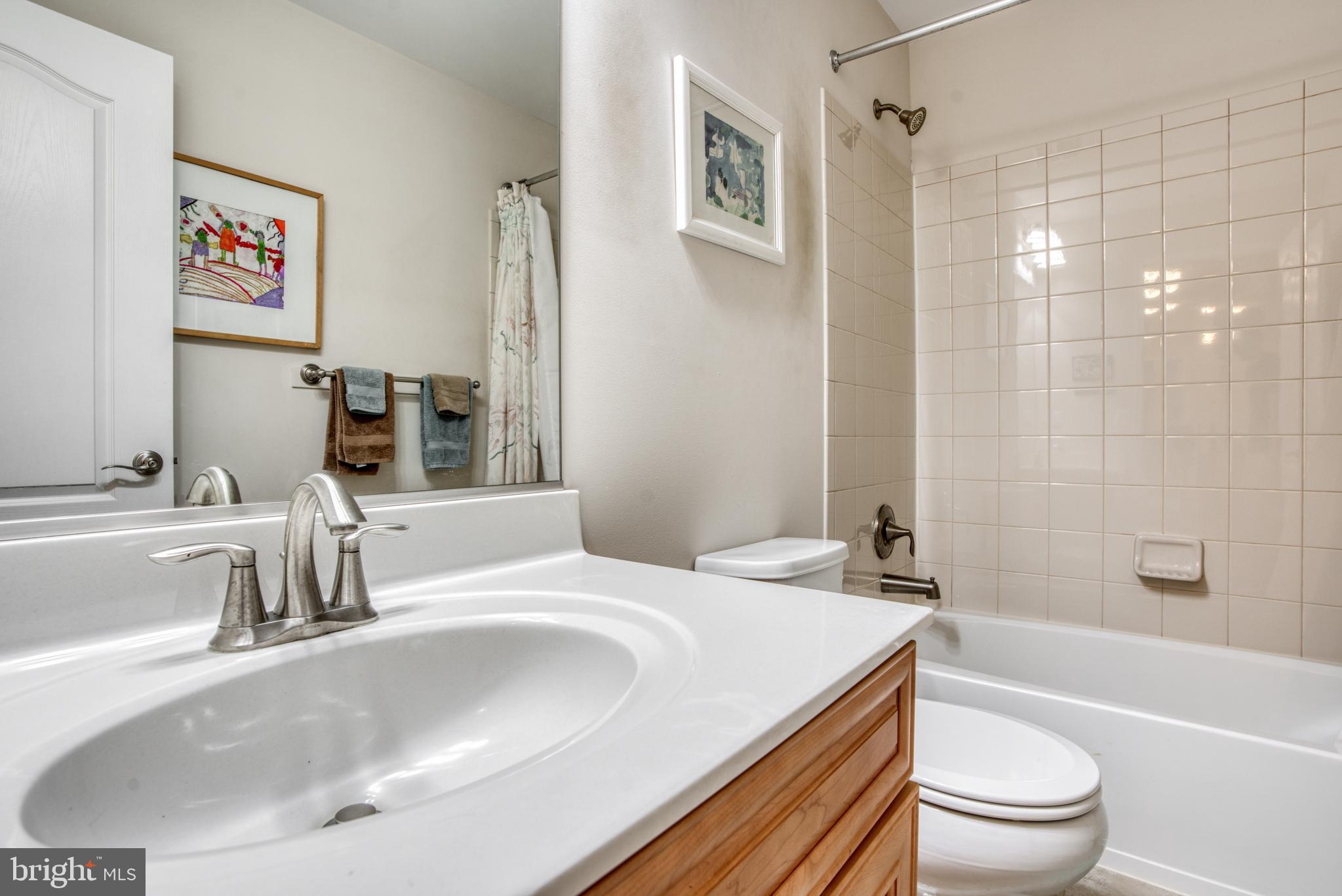 2344 Sweet Meadow Road Baltimore, MD 21209 - Photo 51 of 76 a bathroom with a granite countertop sink a toilet and a bathtub