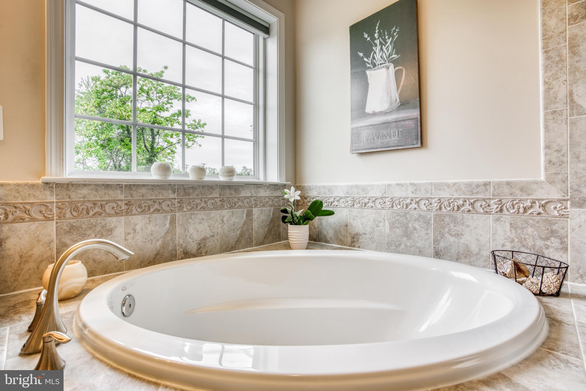 2344 Sweet Meadow Road Baltimore, MD 21209 - Photo 63 of 76 a white bath tub sitting in a bathroom
