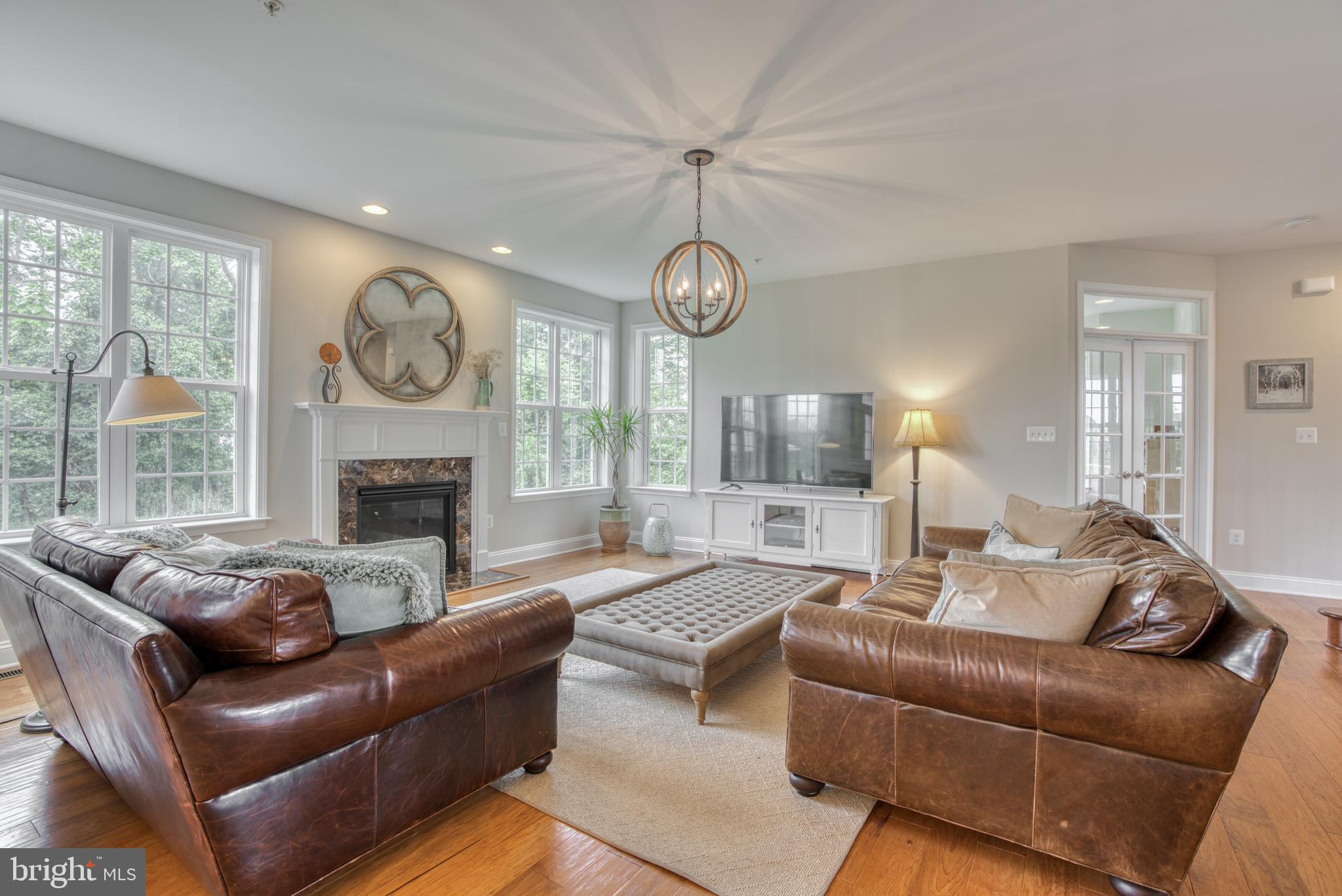 2344 Sweet Meadow Road Baltimore, MD 21209 - Photo 8 of 76 a living room with furniture a clock and a large window
