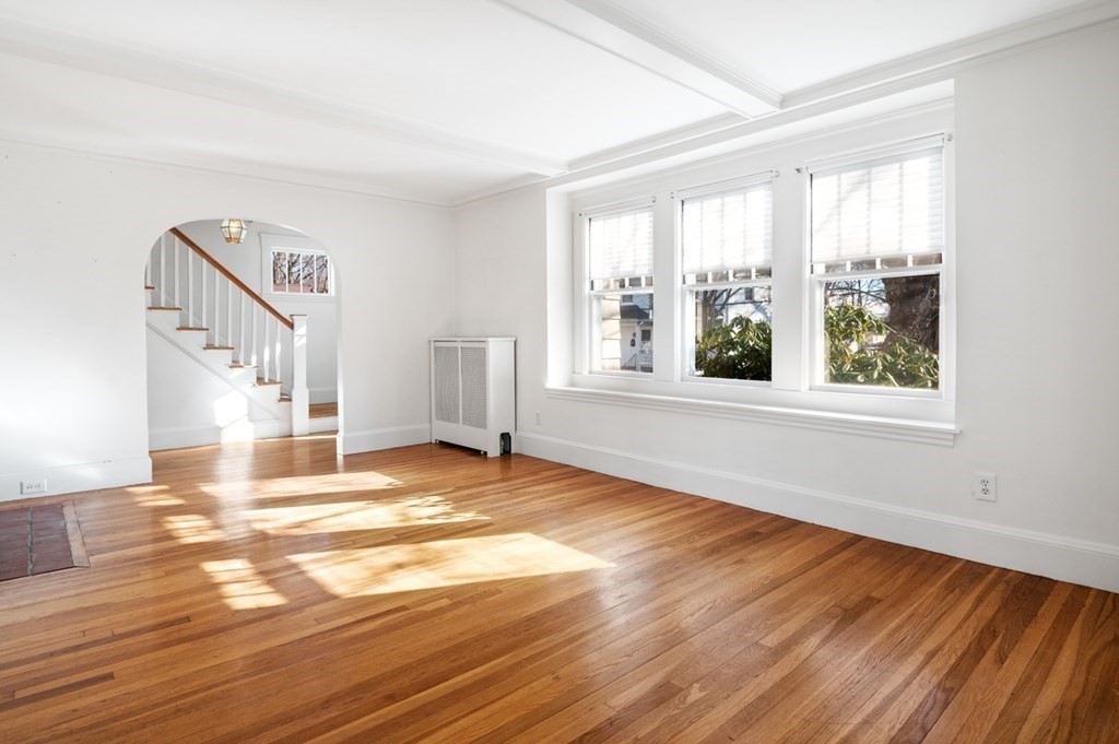 6 Stone Street Saugus, MA 01906 - Photo 13 of 39 a view of an empty room with wooden floor and a window