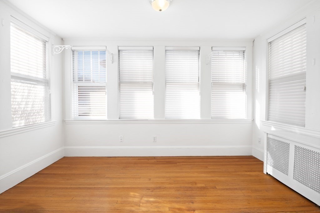 6 Stone Street Saugus, MA 01906 - Photo 14 of 39 a view of an empty room with wooden floor and a window