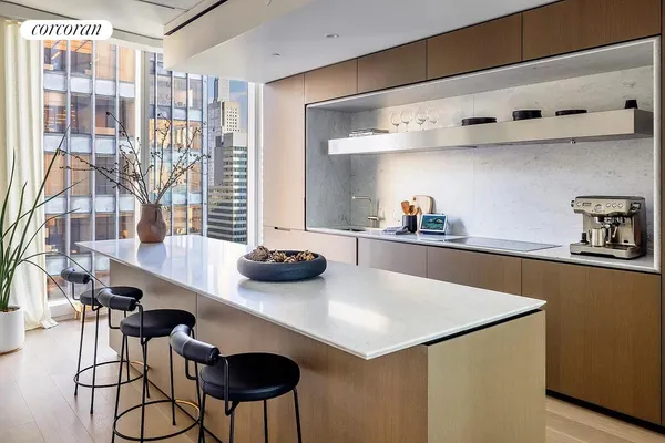 a dining room with furniture and a floor to ceiling window