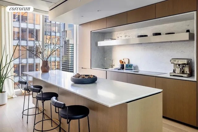 a dining room with furniture and a floor to ceiling window