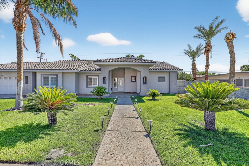 2120 West Nicola Road Palm Springs, CA 92262 - Photo 1 of 30 a front view of a house with a garden and plants