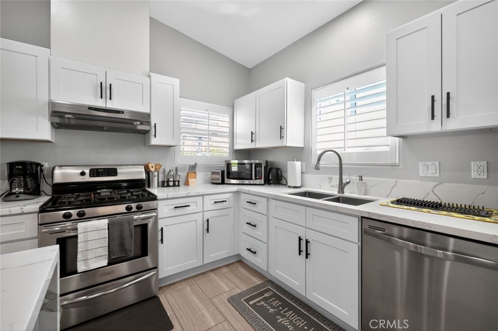 2120 West Nicola Road Palm Springs, CA 92262 - Photo 11 of 30 a kitchen with cabinets stainless steel appliances and a sink