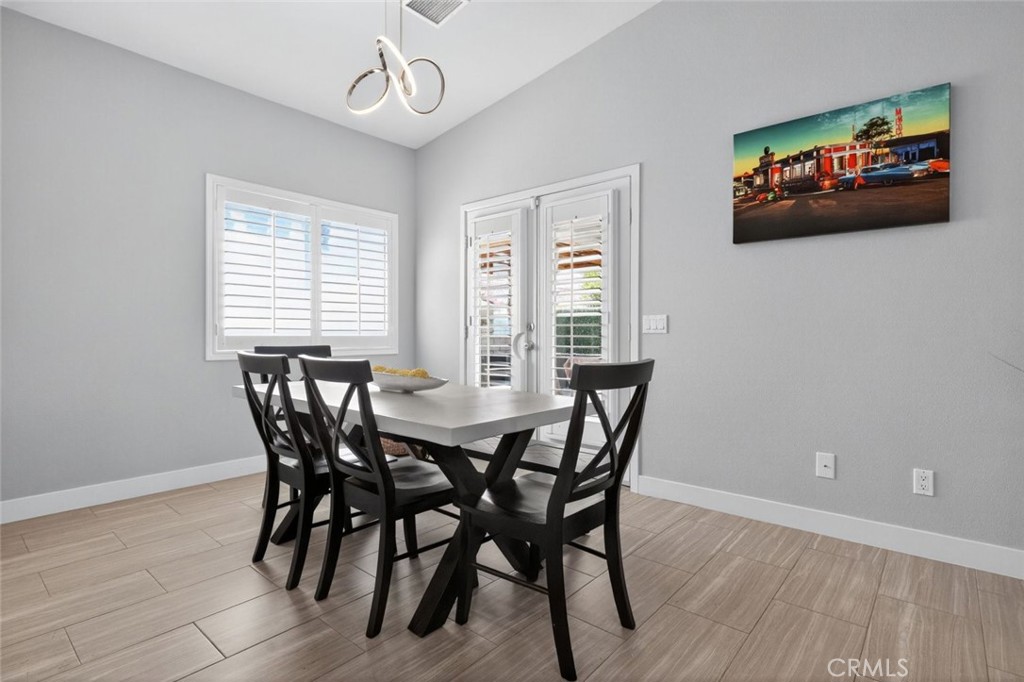 2120 West Nicola Road Palm Springs, CA 92262 - Photo 12 of 30 a view of a dining room with furniture window and wooden floor