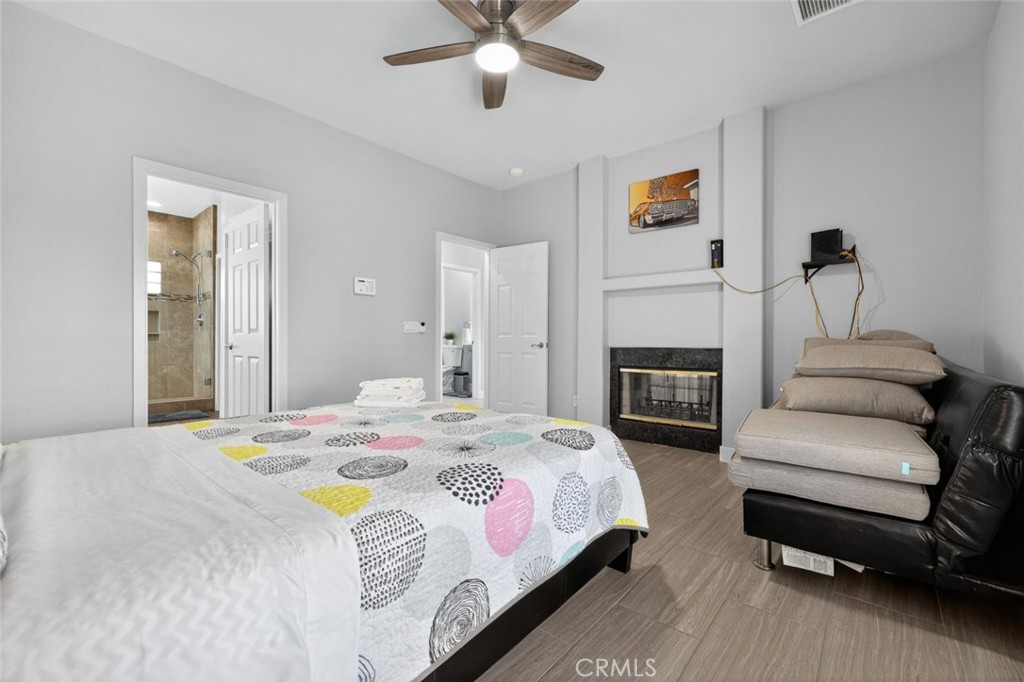 2120 West Nicola Road Palm Springs, CA 92262 - Photo 13 of 30 a bedroom with a bed couch and a fireplace