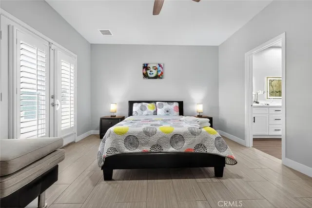 a bedroom with bed and wooden floor