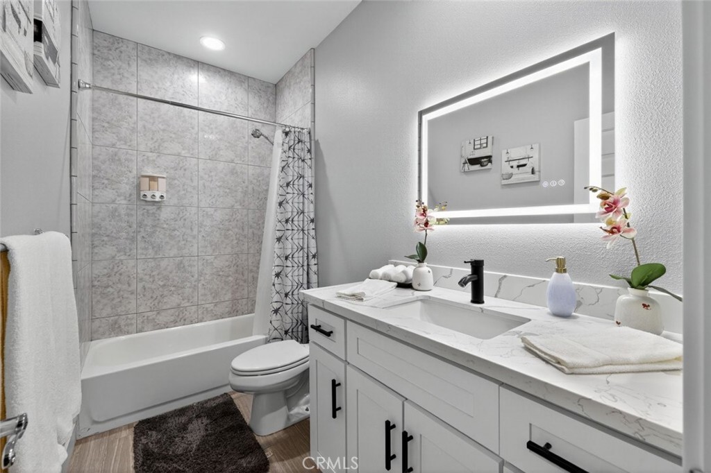 2120 West Nicola Road Palm Springs, CA 92262 - Photo 20 of 30 a bathroom with a granite countertop sink toilet a large mirror a shower and a bathtub