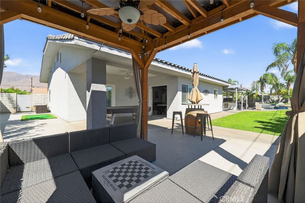 2120 West Nicola Road Palm Springs, CA 92262 - Photo 22 of 30 a view of a patio with table and chairs with wooden floor and fence