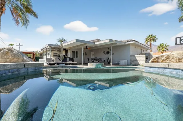 a view of a backyard with swimming pool