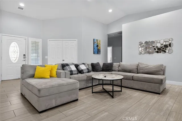 a kitchen with a dining table chairs and white cabinets