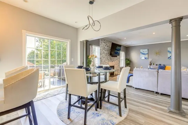 a dining room with furniture a chandelier and wooden floor