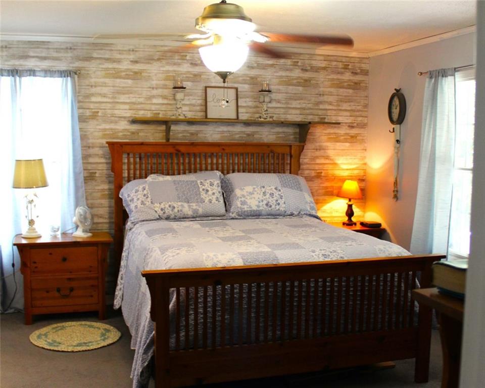 396 Old Harden Orchard Road Commerce, GA 30529 - Photo 13 of 21 a bedroom with a bed and wooden floor