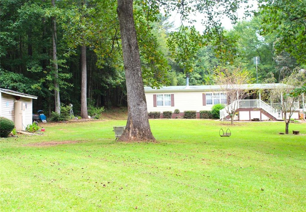 396 Old Harden Orchard Road Commerce, GA 30529 - Photo 21 of 21 a view of a house with a yard porch and sitting area