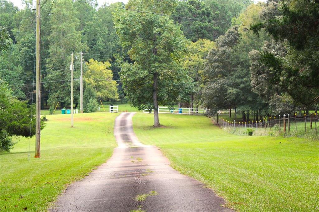 396 Old Harden Orchard Road Commerce, GA 30529 - Photo 3 of 21 a view of a swimming pool with a yard