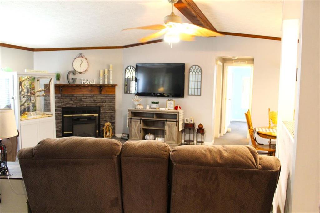 396 Old Harden Orchard Road Commerce, GA 30529 - Photo 10 of 21 a living room with furniture a fireplace and a flat screen tv