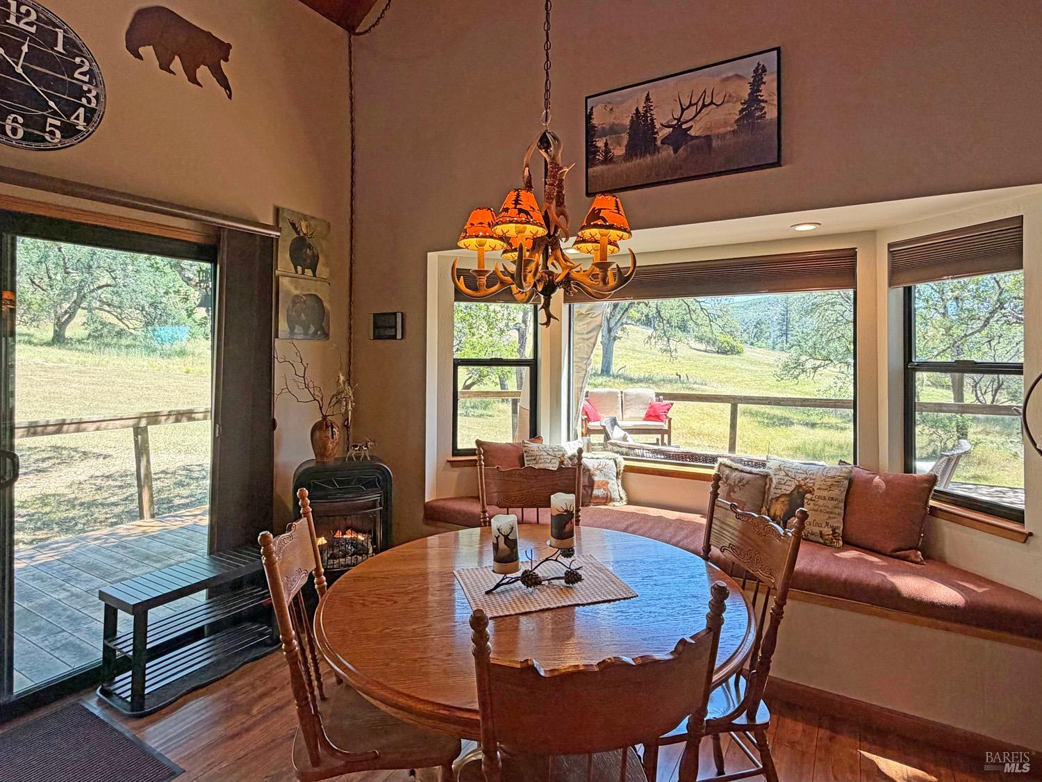 31312 High Point Road Potter Valley, CA 95469 - Photo 16 of 58 a view of a dining room with furniture a chandelier and wooden floor