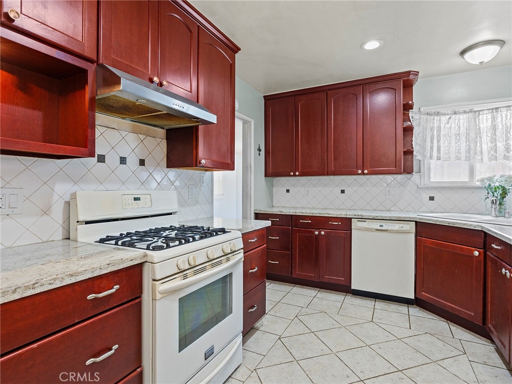 2724 Scott Road Burbank, CA 91504 - Photo 11 of 43 a kitchen with stainless steel appliances granite countertop a stove sink and cabinets