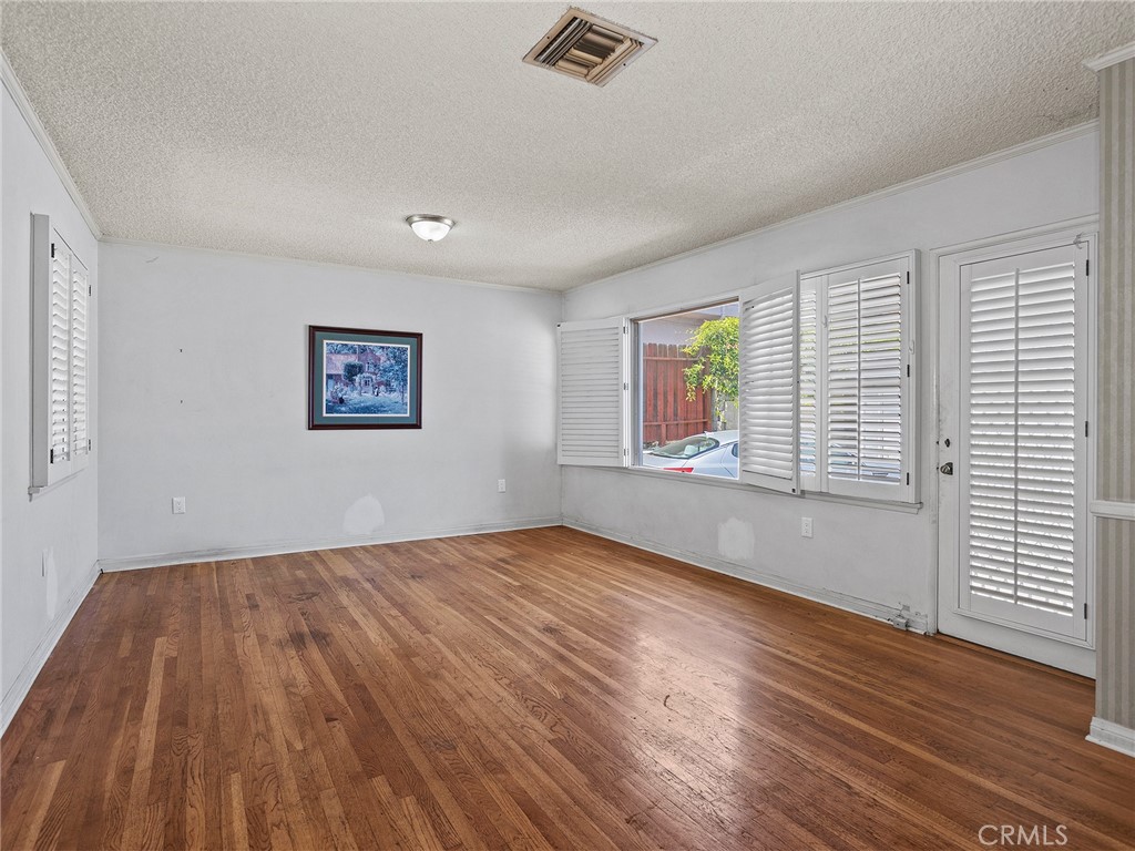 2724 Scott Road Burbank, CA 91504 - Photo 14 of 43 a view of an empty room with wooden floor and a window