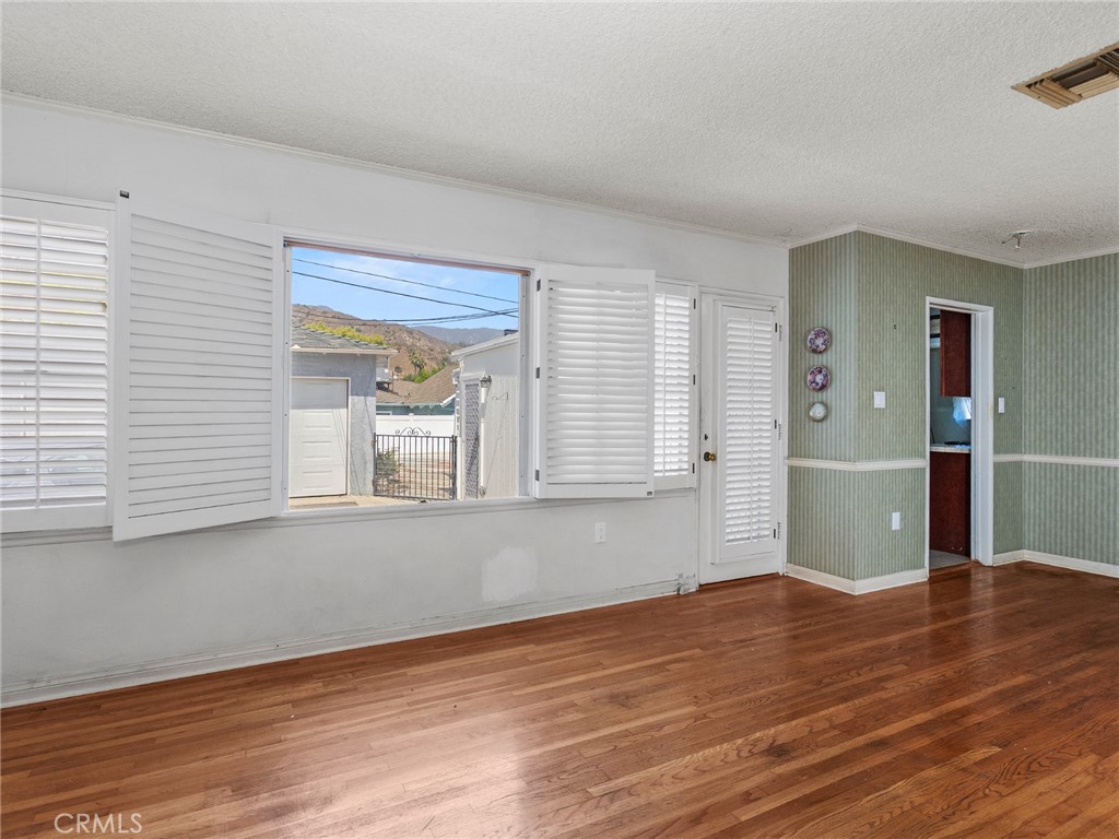 2724 Scott Road Burbank, CA 91504 - Photo 16 of 43 a view of an empty room with wooden floor and a window