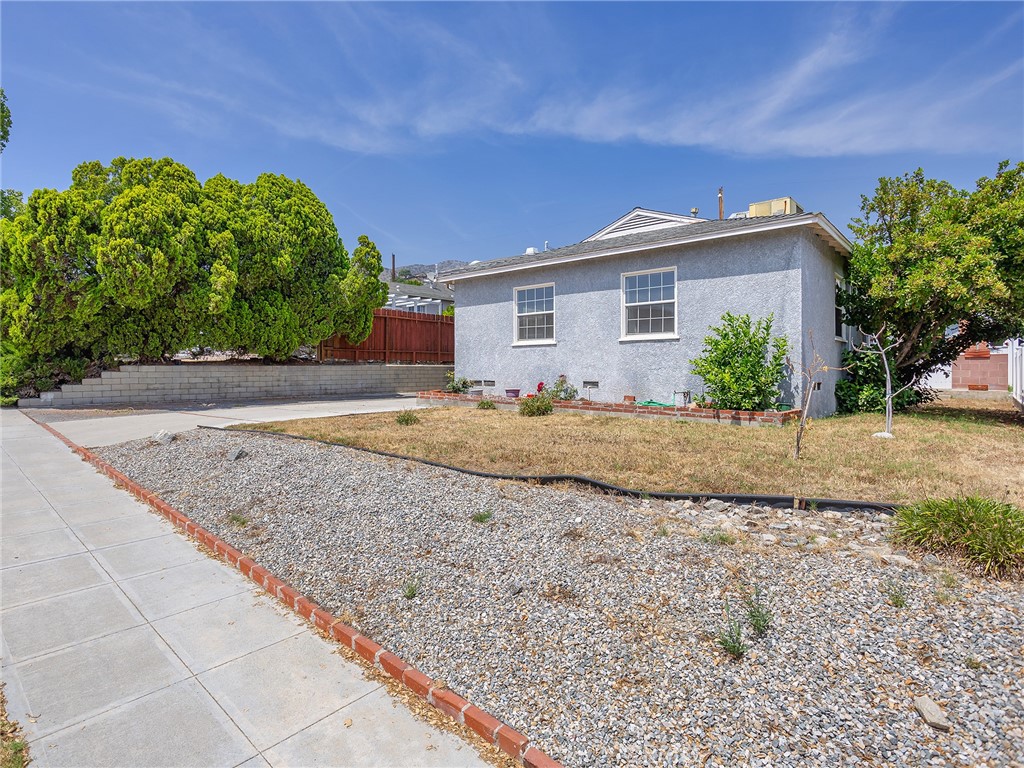 2724 Scott Road Burbank, CA 91504 - Photo 5 of 43 a front view of a house with a garden and yard