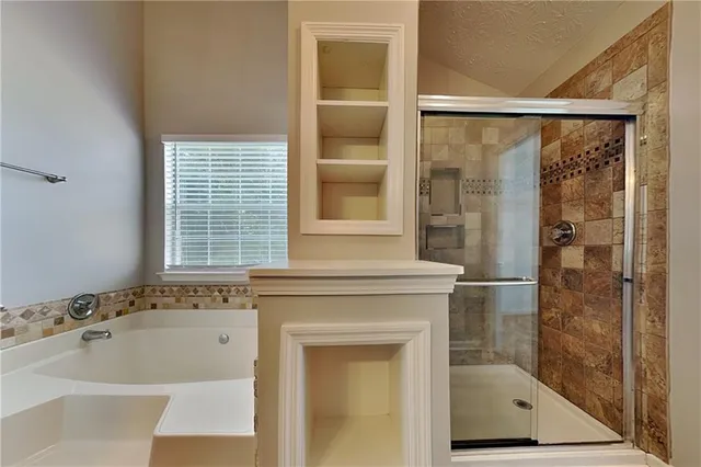 a bathroom with a bathtub and a shower