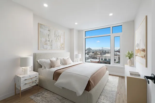 a bedroom with a large bed and a large window