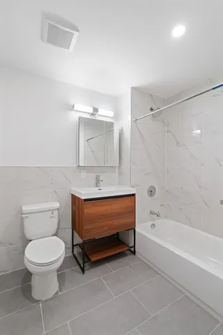 a bathroom with a toilet a sink and bathtub