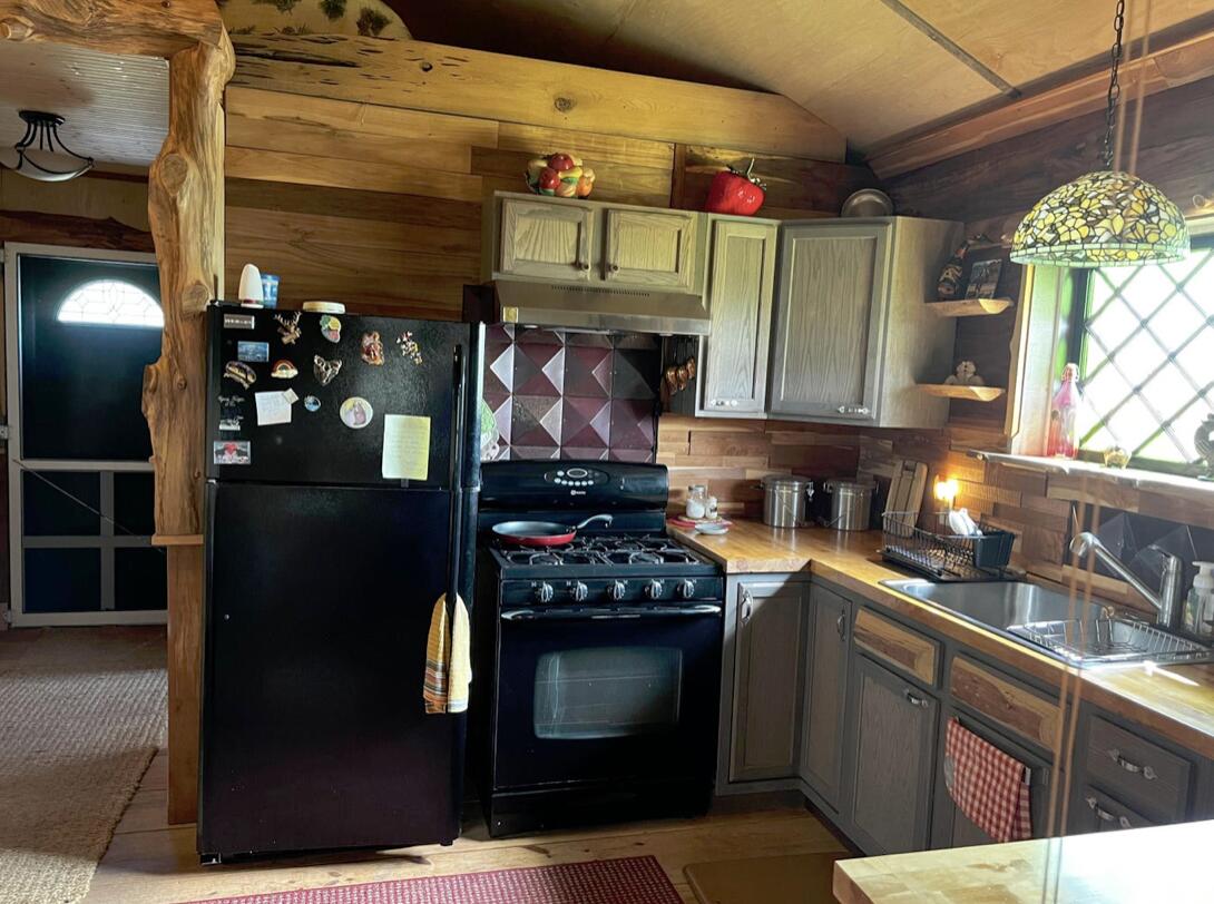 5 West A W Chapel Road Laurel Hill, FL 32567 - Photo 6 of 14 a kitchen with stainless steel appliances granite countertop a refrigerator and a stove