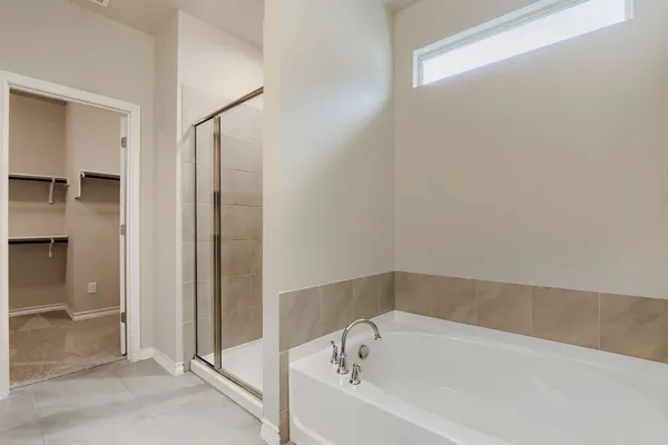 a white bath tub sitting in a en suite bathroom