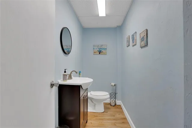 a bathroom with a toilet a sink and mirror