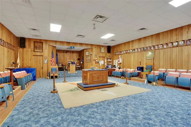 a living room with furniture kitchen view and a large window