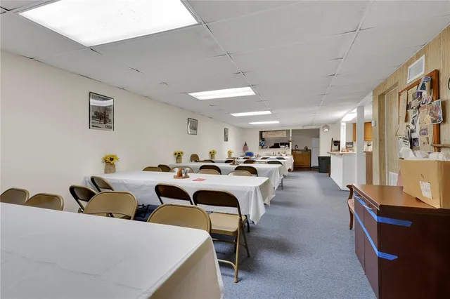 a large room with lots of white furniture