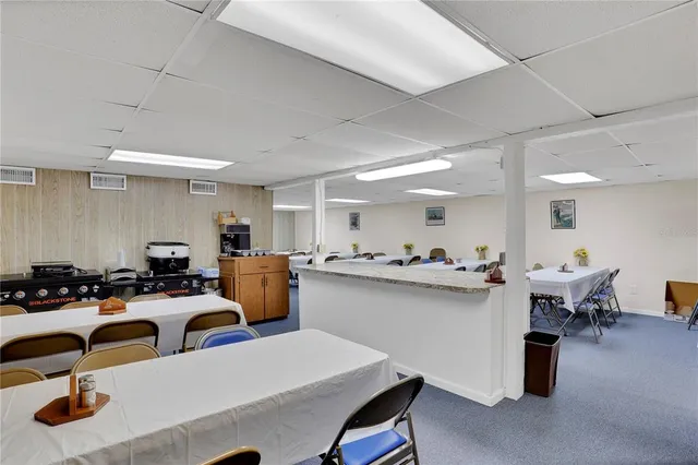 a kitchen with a sink a stove and chairs